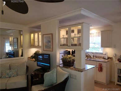 Kitchen to the back of the picture and living room