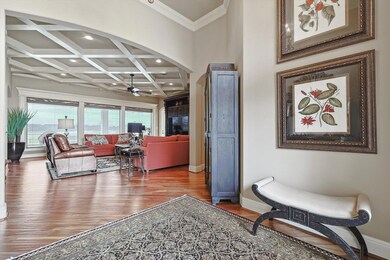 Coffered ceiling and a wall of windows overlooking the pool and golf course