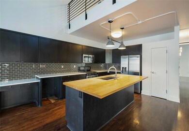 Kitchen with decorative backsplash, a sink, stain