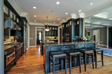 The expansive & open Kitchen will certainly be a gathering place for family & friends.  Bar stools fit at the end of the large breakfast bar. Lots of storage cabinets, , a walk-in pantry, recessed lighting, trash compactor & garbage disposal.