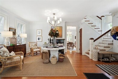 Foyer, stairwell and a glimpse of the dining room.