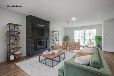 Living room featuring baseboards, a fireplace, and