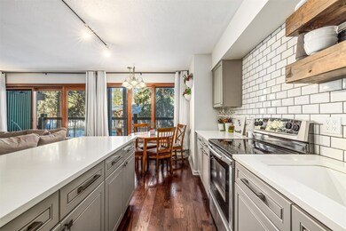 Kitchen with tasteful backsplash, track lighting,