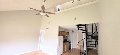 Spiral staircase gives the  kitchen a dramatic loo