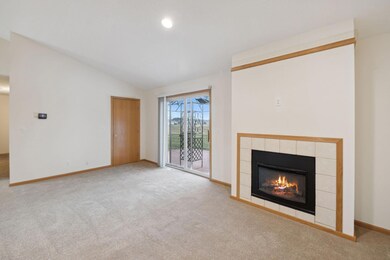 Main floor living room with a cozy electric fireplace