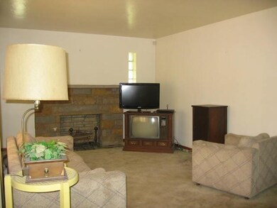 The nineteen-foot living room is brightened by a l