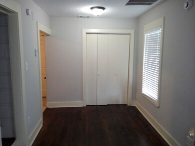Hall with dark hardwood / wood-style floors and a 