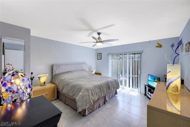 Bedroom with light tile patterned floors, access t