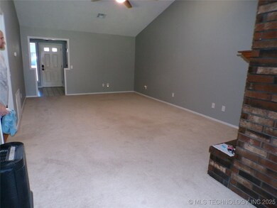 Huge living room with high ceilings and fireplace.