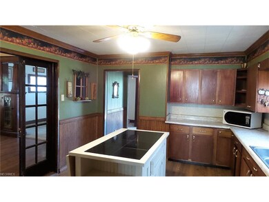 Kitchen with large island.  Appliances stay.  Ceil