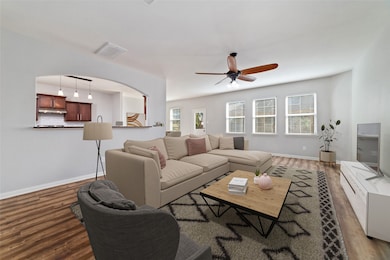 Spacious living room opens to the dining room & kitchen. Tons of natural lighting with the wall of windows overlooking the backyard. Virtually staged.