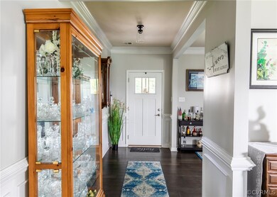Foyer with wide plank hardwood floors & moldings