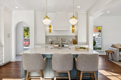 Sage green island full of storage and plenty of seating. Classic cafe pendent lights provide plenty of task light and style.