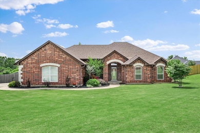 French country style house with brick siding and a shingled roof