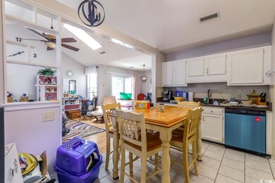 Kitchen featuring dishwasher, ceiling fan, white cabinetry, backsplash, and vaulted ceiling
