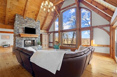 Living area with baseboards, a chandelier, beam ce