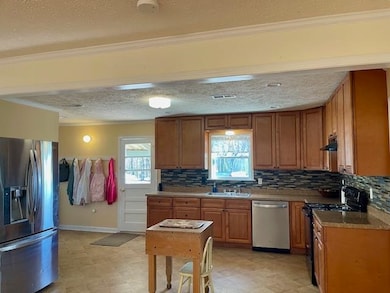 Kitchen featuring crown molding, a sink, light flo