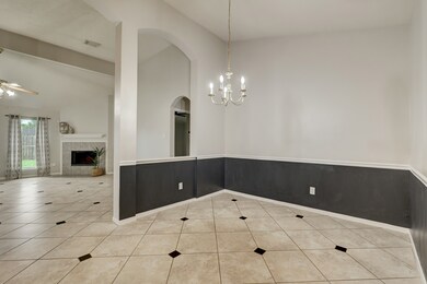 The dining room has a chair rail and pretty accent paint that will be so easy to decorate with! The primary bedroom is just through the arched opening beyond the dining room wall.