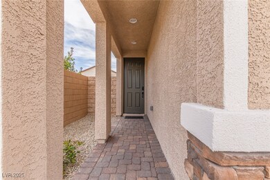 Property entrance with stucco siding and fence