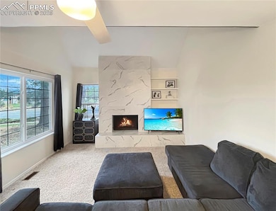 Living room featuring carpet floors, lofted ceilin