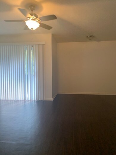 Spare room featuring ceiling fan and wood-type flo