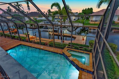 Pool at dusk with an in ground hot tub and a water