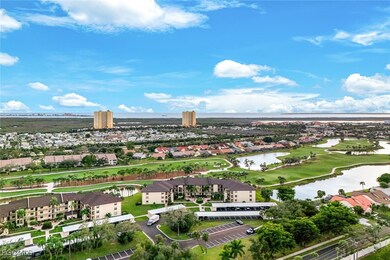 Aerial perspective of suburban area with a large body of water and a golf course