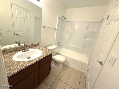 Bathroom featuring vanity, tub / shower combinatio