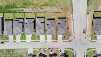 An aerial view of a spacious subdivision lot, high