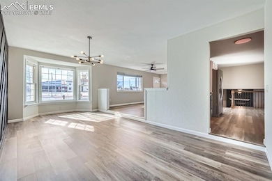 Unfurnished living room with ceiling fan with nota