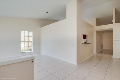 VIEW FROM FOYER INTO LIVING ROOM AND DINING ROOM