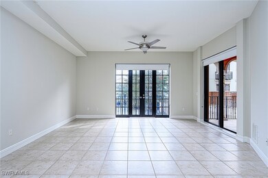 Empty room featuring ceiling fan, light tile patte