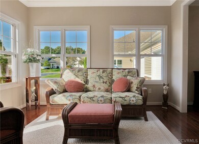 Bright Sunroom with windows on two sides and opens