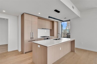 Kitchen featuring light brown cabinetry, a sink, 