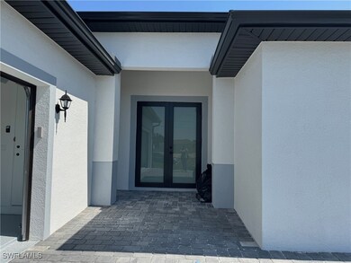 Property entrance featuring stucco siding and fren