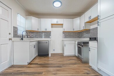 Kitchen featuring light countertops, white cabinet