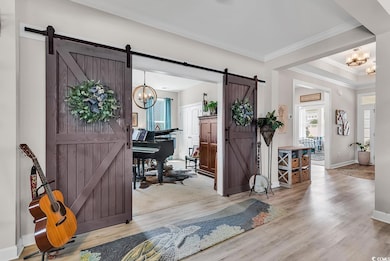 Entryway featuring baseboards, an inviting chandel
