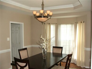Dining room with hardwood floor, tray ceiling, cro