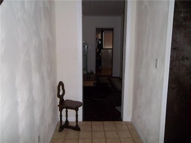 Entry with ceramic tile and original woodwork. New