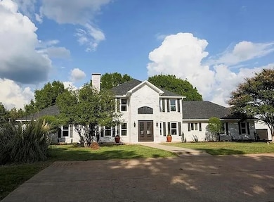 White brick exterior with grand entry and beautifu