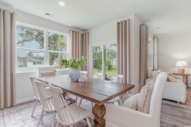Dining area with hardwood / wood-style flooring