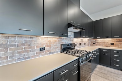 Kitchen featuring black range with gas stovetop, 