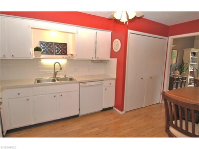 Classic white kitchen with laminate wood floors & 
