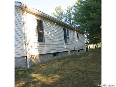 Exterior Back. Faces west.  Concrete pad, electric
