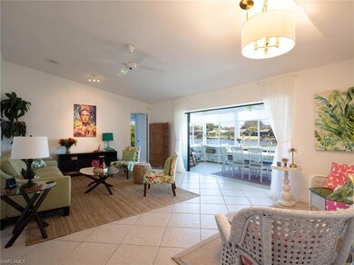 Living room featuring ceiling fan, light tile patt