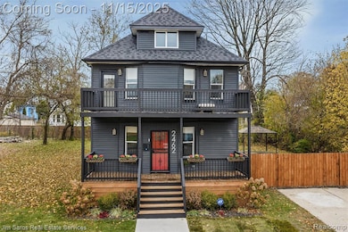Traditional style home featuring roof with shingles and covered porch