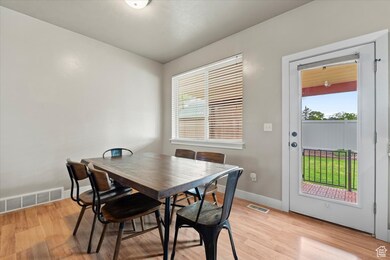 Dining area featuring light wood-style flooring and baseboards