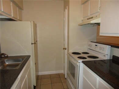 Kitchen featuring sink, white appliances, light ti