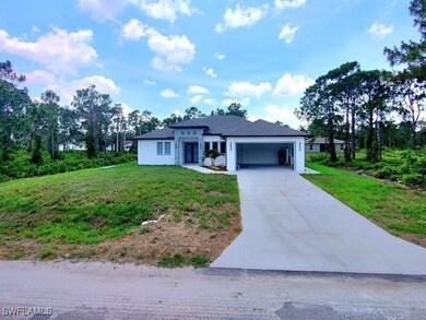 View of front of house featuring driveway, an atta