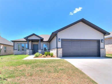 View of front of home with a front yard and a gara